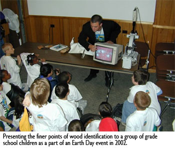 Dr. Alex C. Wiedenhoeft, Presenting the finer points of wood identification to a group of grade school children as a part of an Earth Day event in 2002.